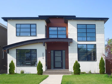 Modern house with large windows and a white LedgeStone exterior